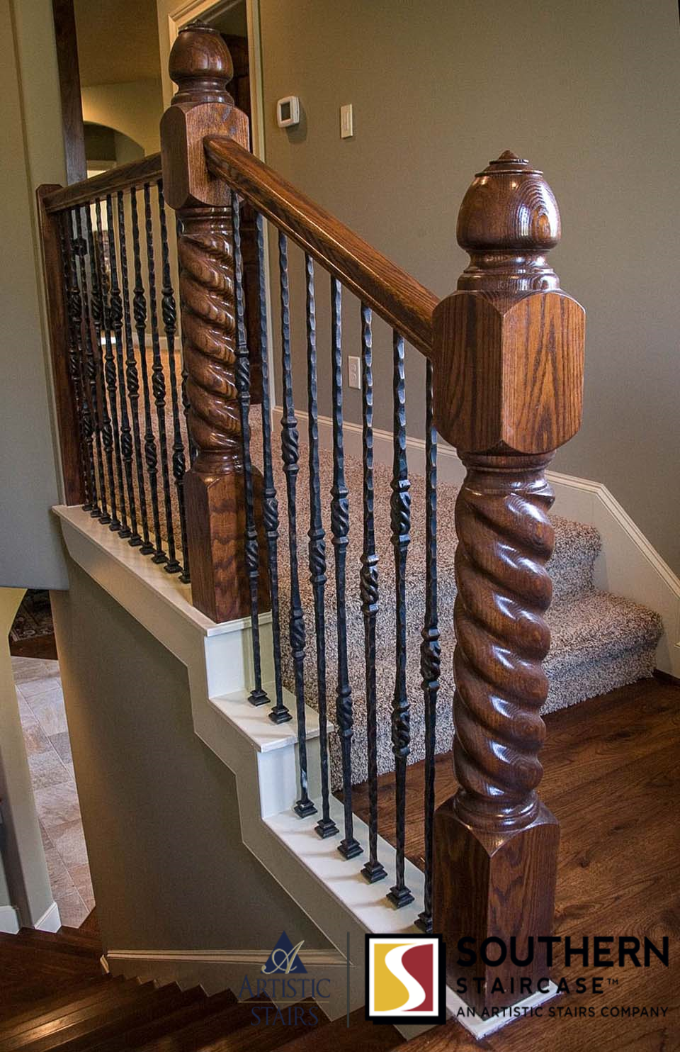 Rustic stair design with thick twisted newels and iron balusters