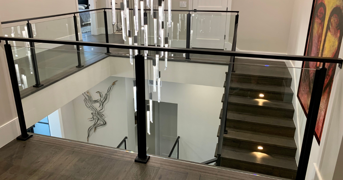 metal and glass stair railing with chandelier