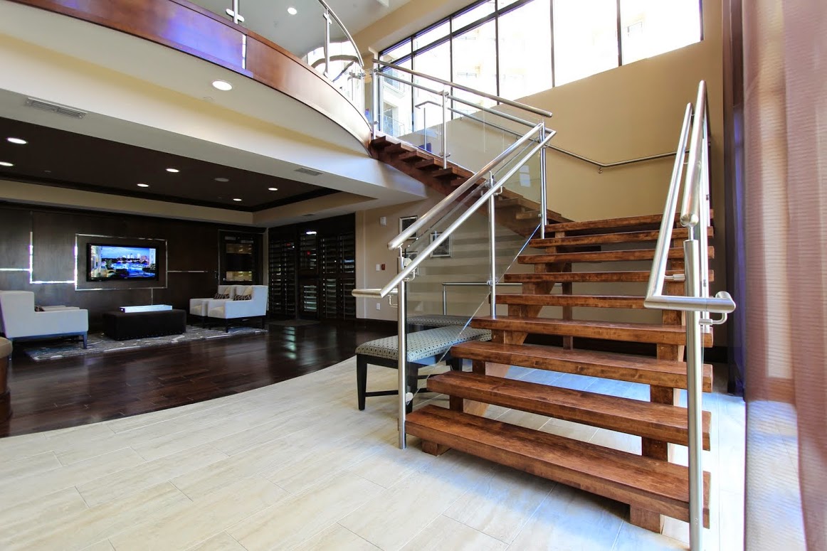 mixed materials staircase design: commercial stainless steel, wood, and glass staircase