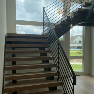 Open riser stairs with iron railings